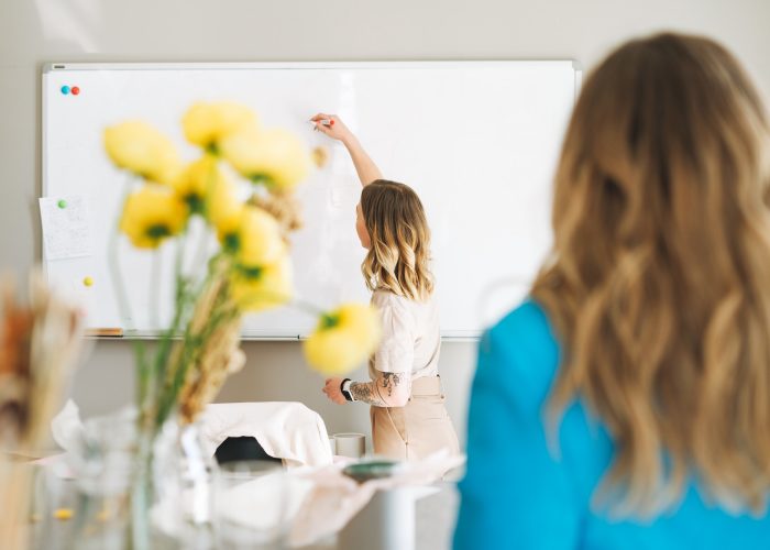 Young blonde woman on lecture in a classroom
